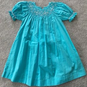 Gorgeous turquoise dress with smocked pearl & rosette details